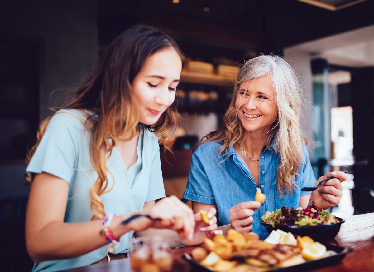 Two women happily enjoying food