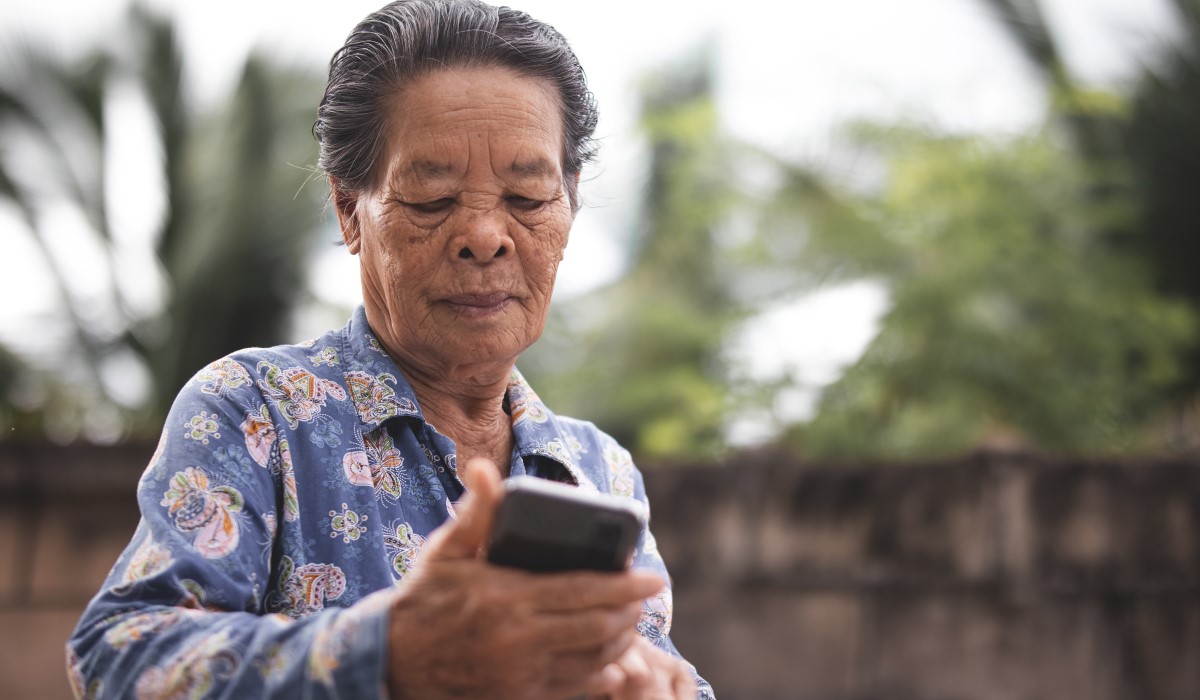 Older woman looking at phone screen