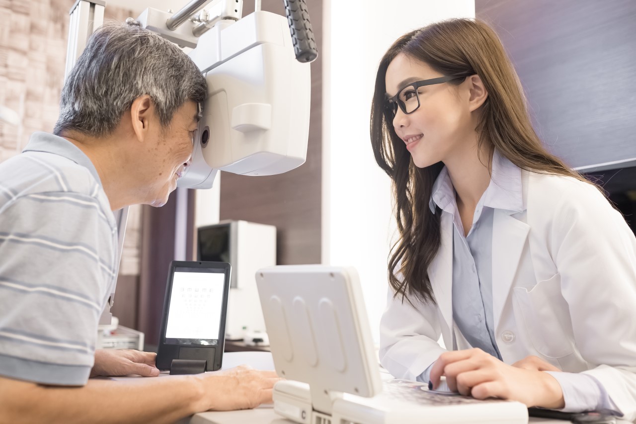 Older woman getting her eyesight checked by woman opthamologist