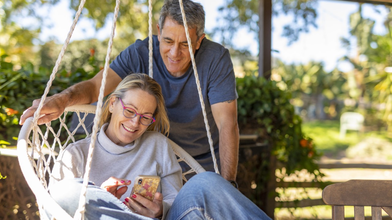 Woman and man looking at phone screen