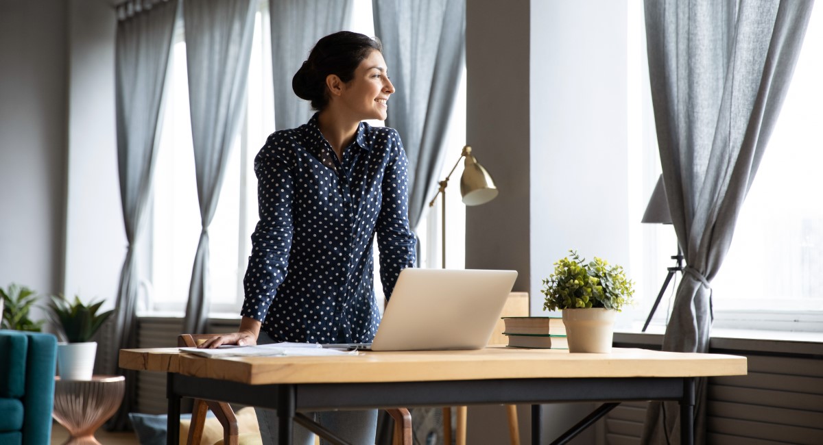 Smiling woman looking out an office window