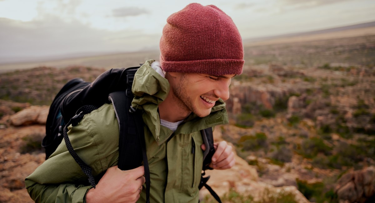 Happy smiling man hiking in the hills