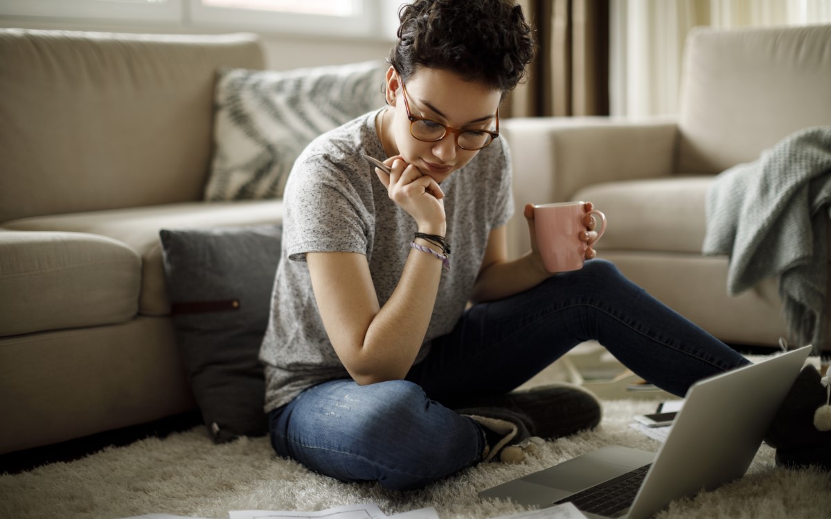 Younger woman looking at her laptop