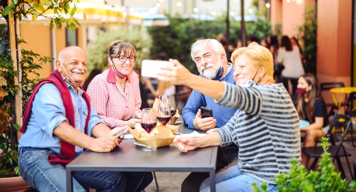 Group of older men and women at a lunch outdoors