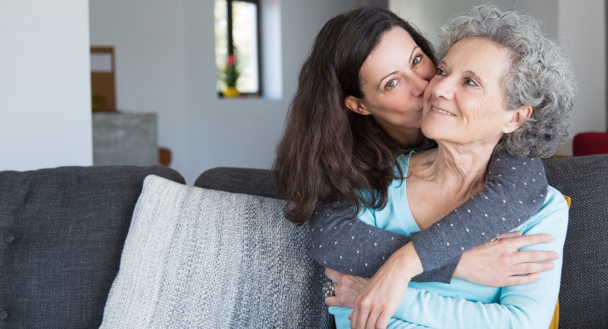 Woman kissing her elderly mother