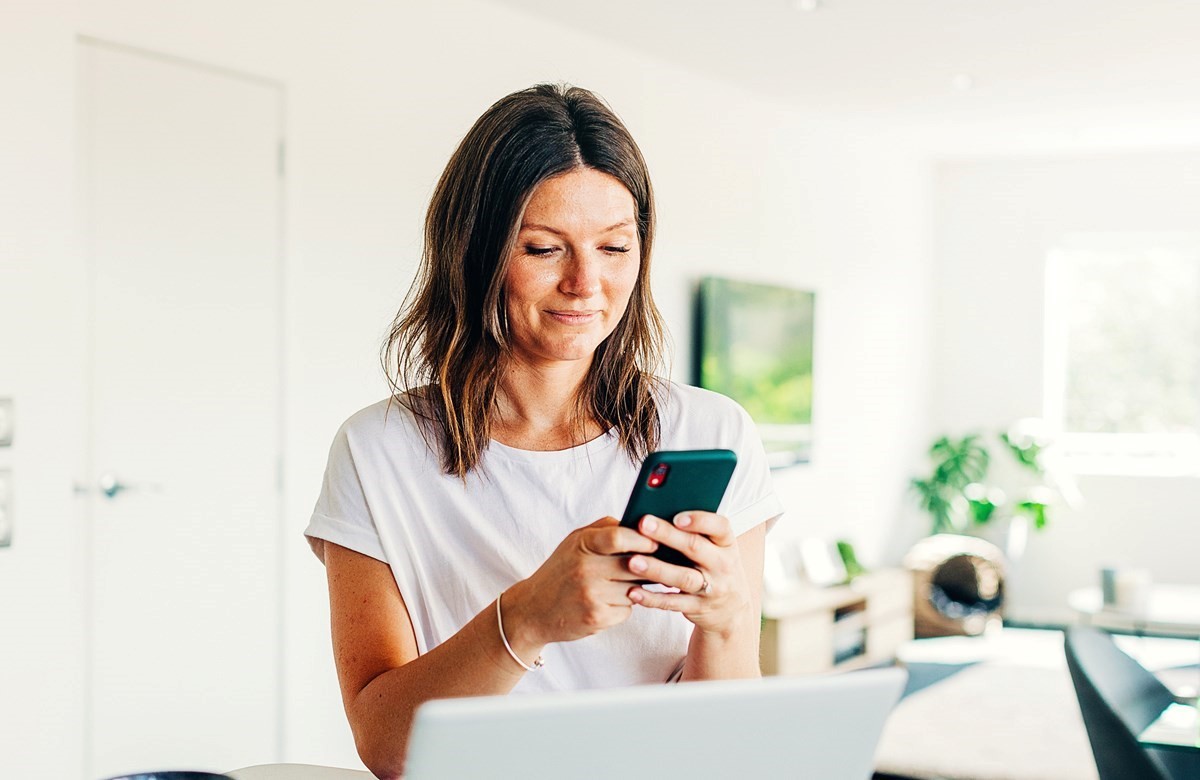 Smiling woman looking at her phone