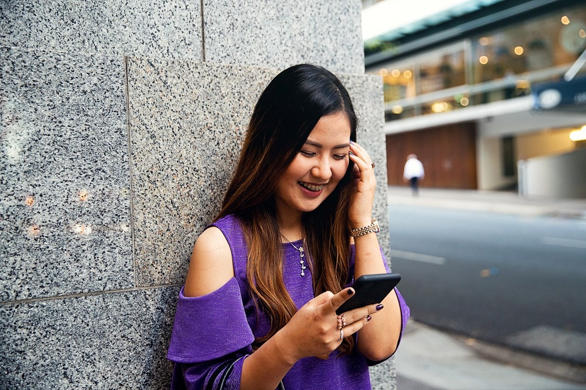 Smiling woman looking at her phone