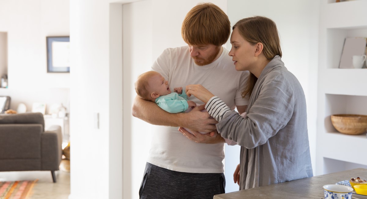 Two men holding their baby