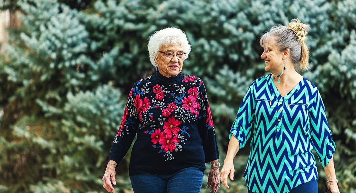 Two older women walking and smiling