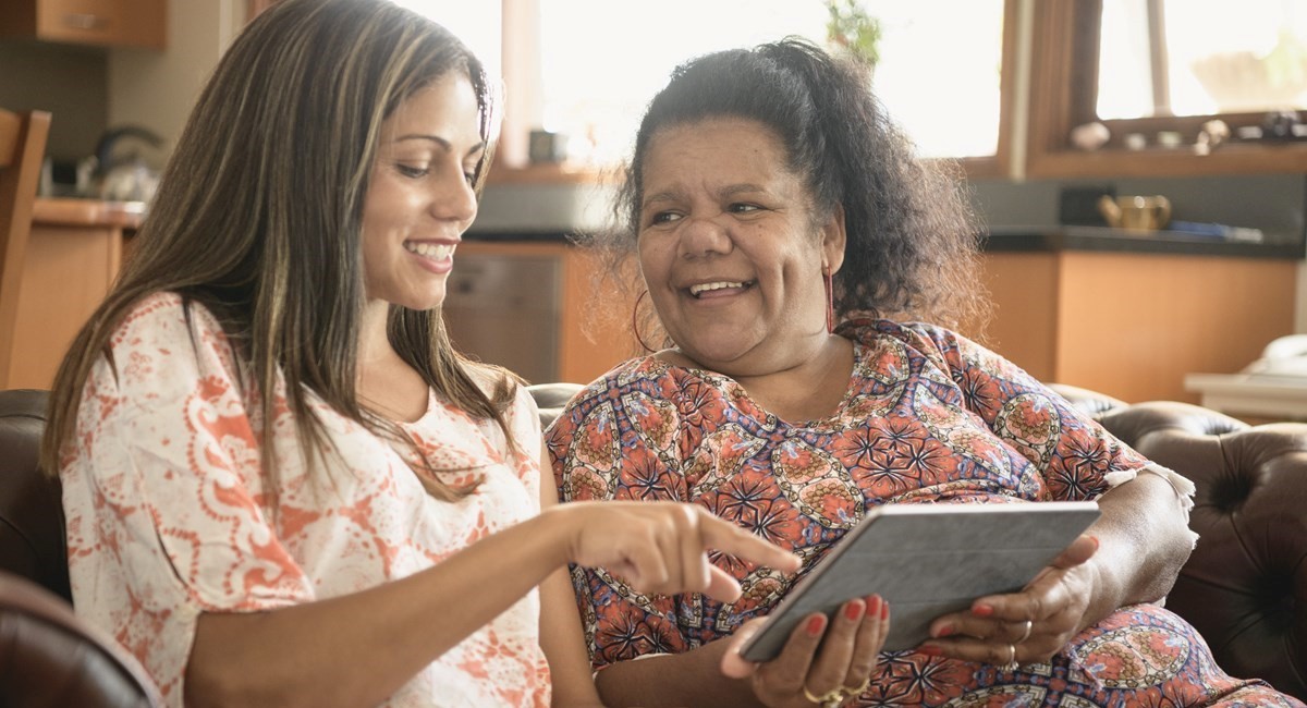 Two Indigenous women laughing and smiling