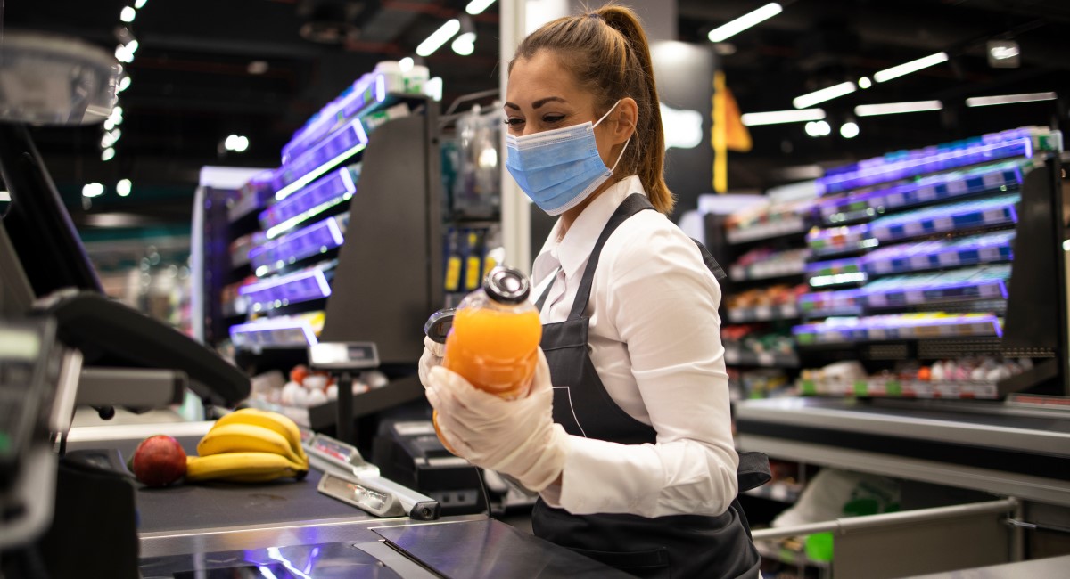 Young woman scanning grocery items