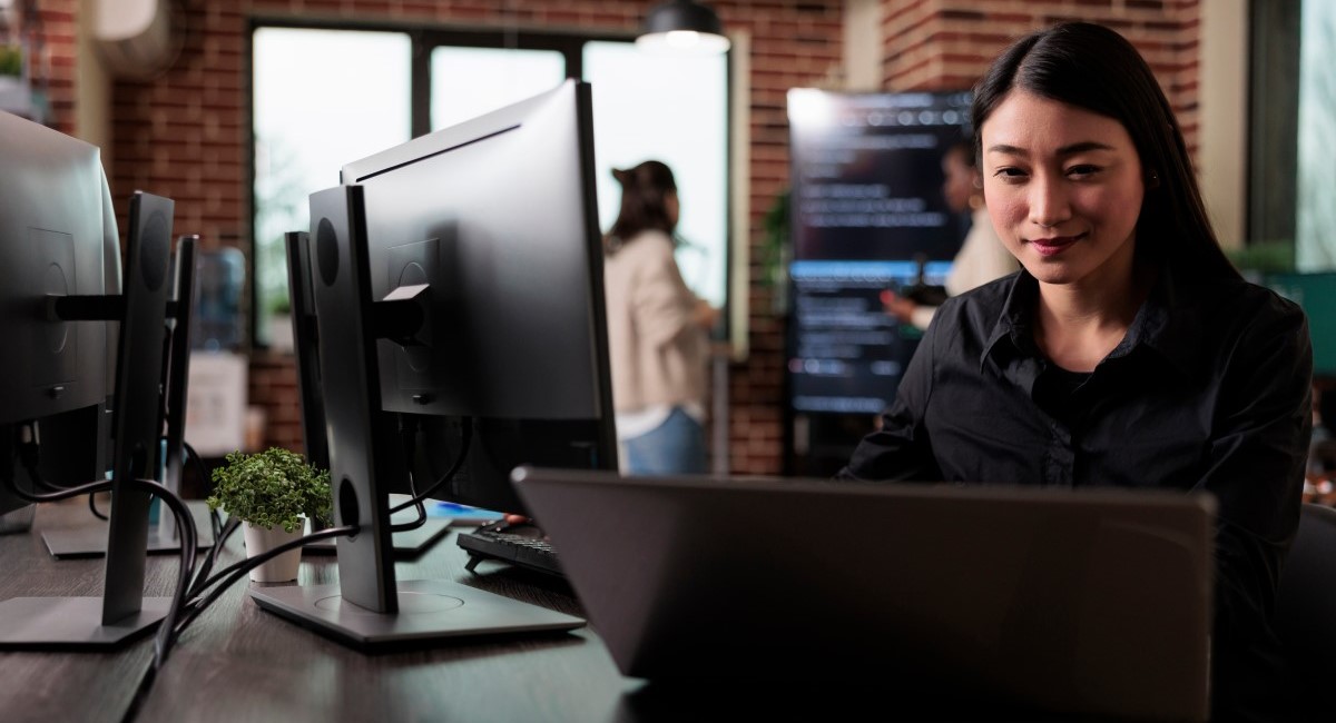 Woman looking at computer screens