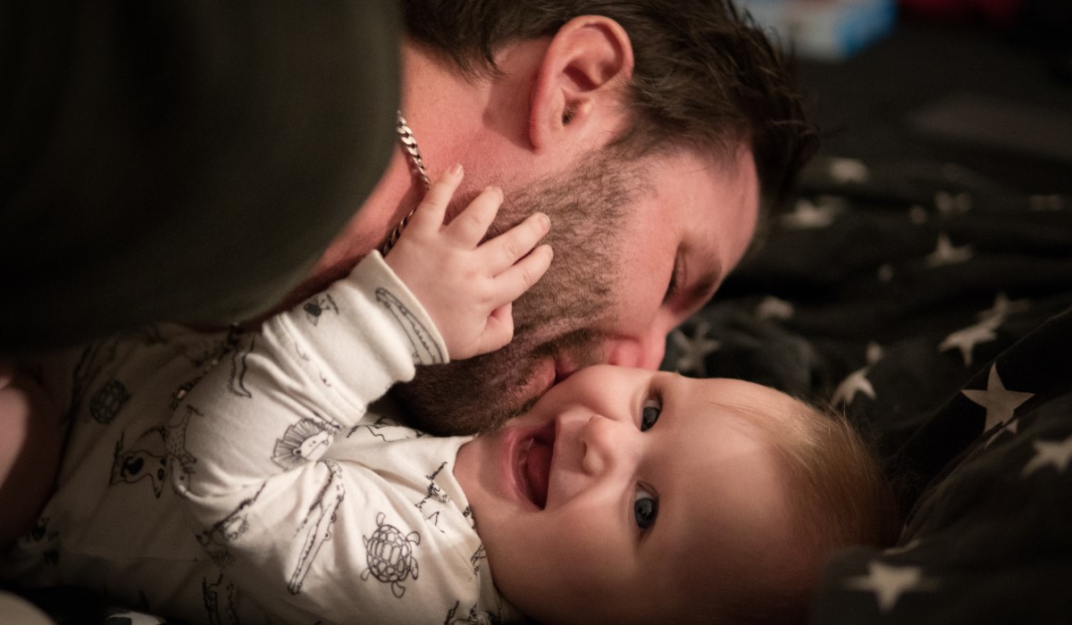 Dad kissing baby
