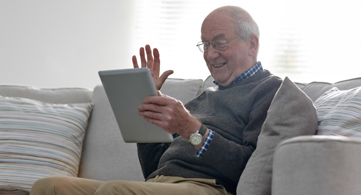 Older man facetiming on ipad