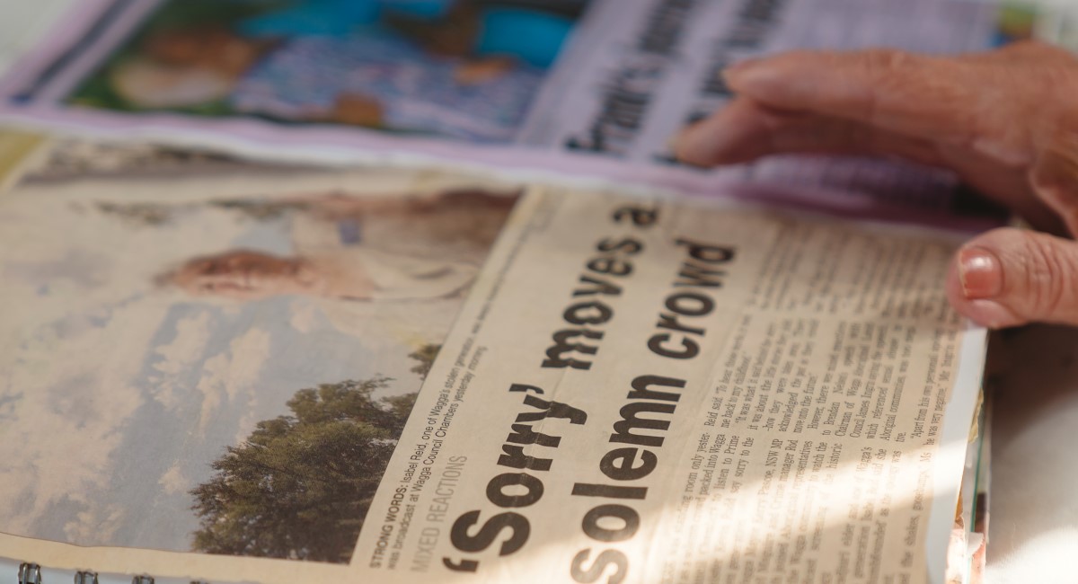 Wiradjuri Elder Aunty Isabel Reid looking through newspaper clippings