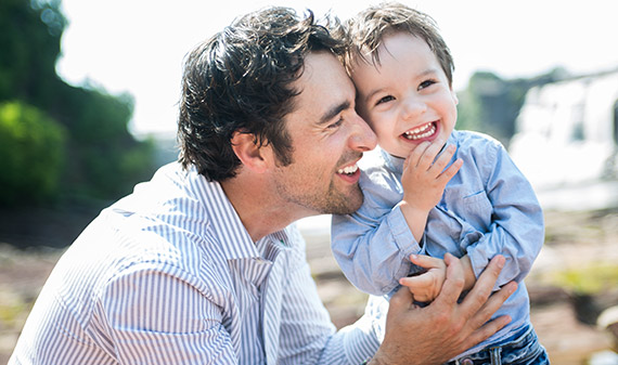 Man with young son, both smiling