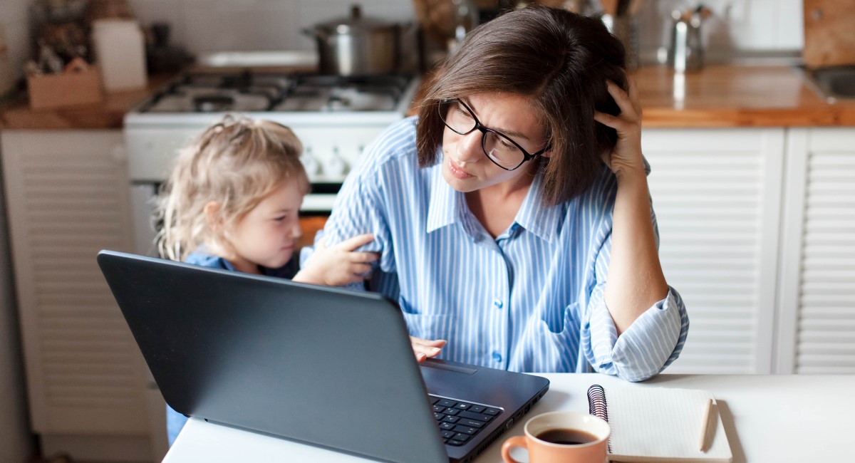 Mother looking at laptop with child