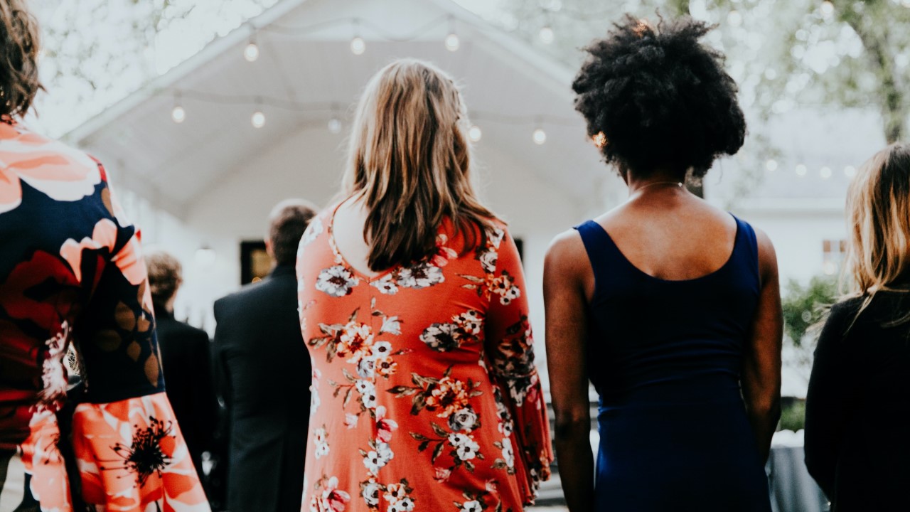 backs of two women attending a community event