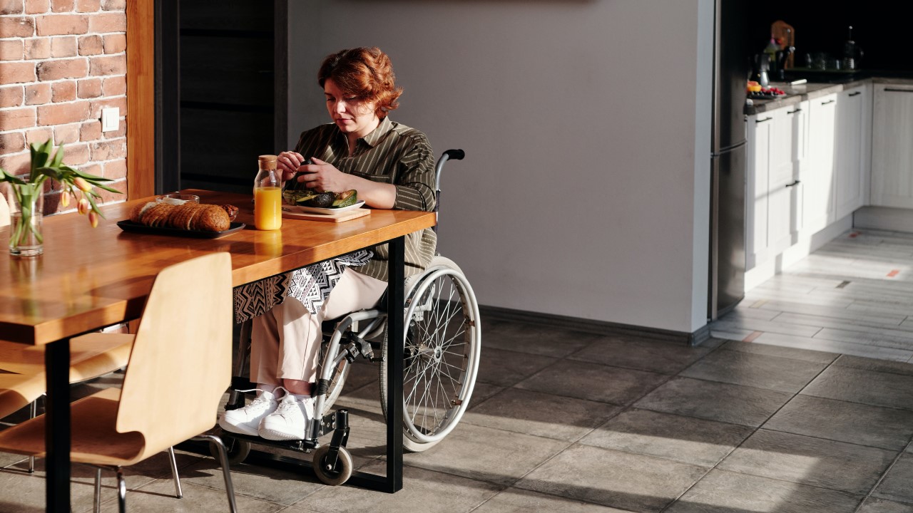 Woman in wheelchair in her kitchen