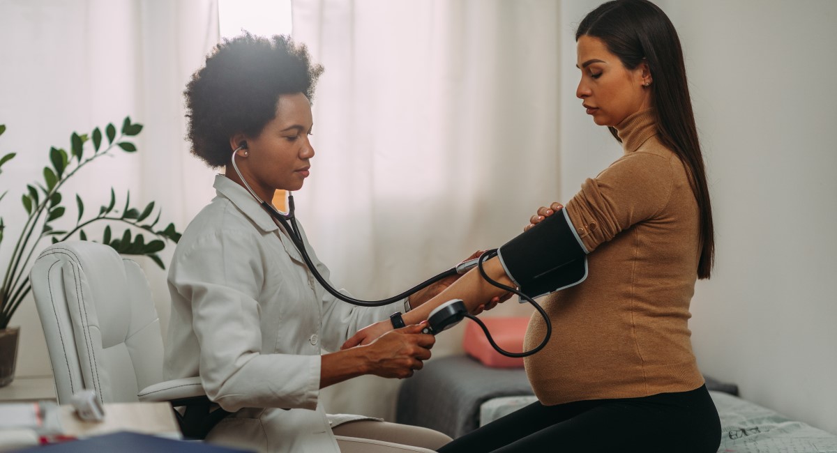 Pregnant woman having her blood pressure checked