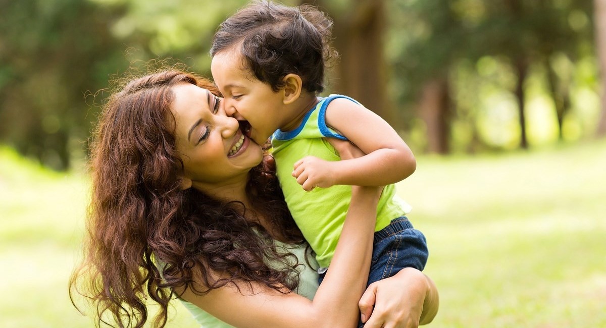 Smiling woman looking happy with toddler