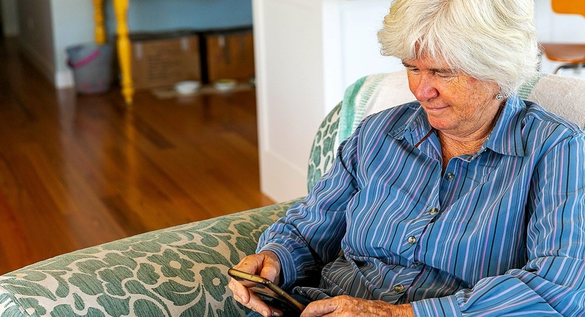 Older woman looking at phone screen 