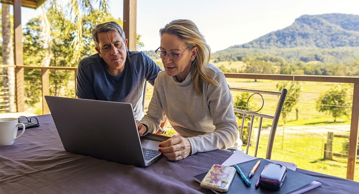 Man and woman looking at a laptop screen