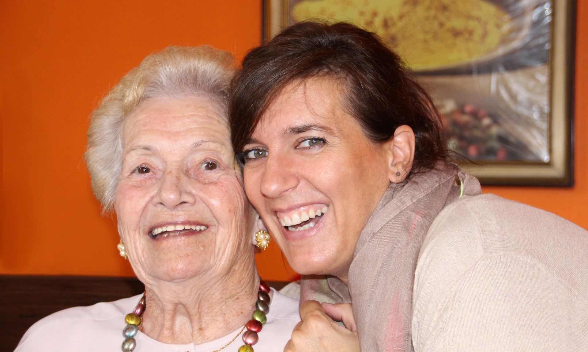Elderly woman, smiling, with her happy support worker