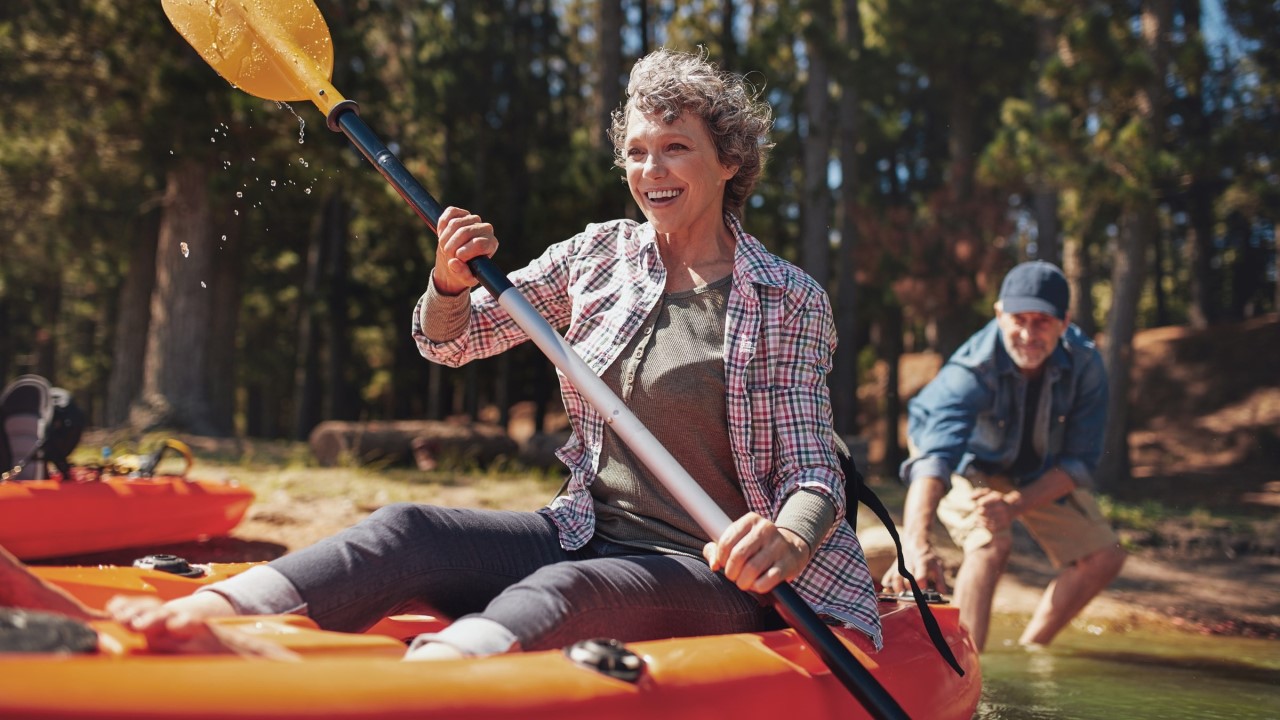 Older woman paddling in canoe