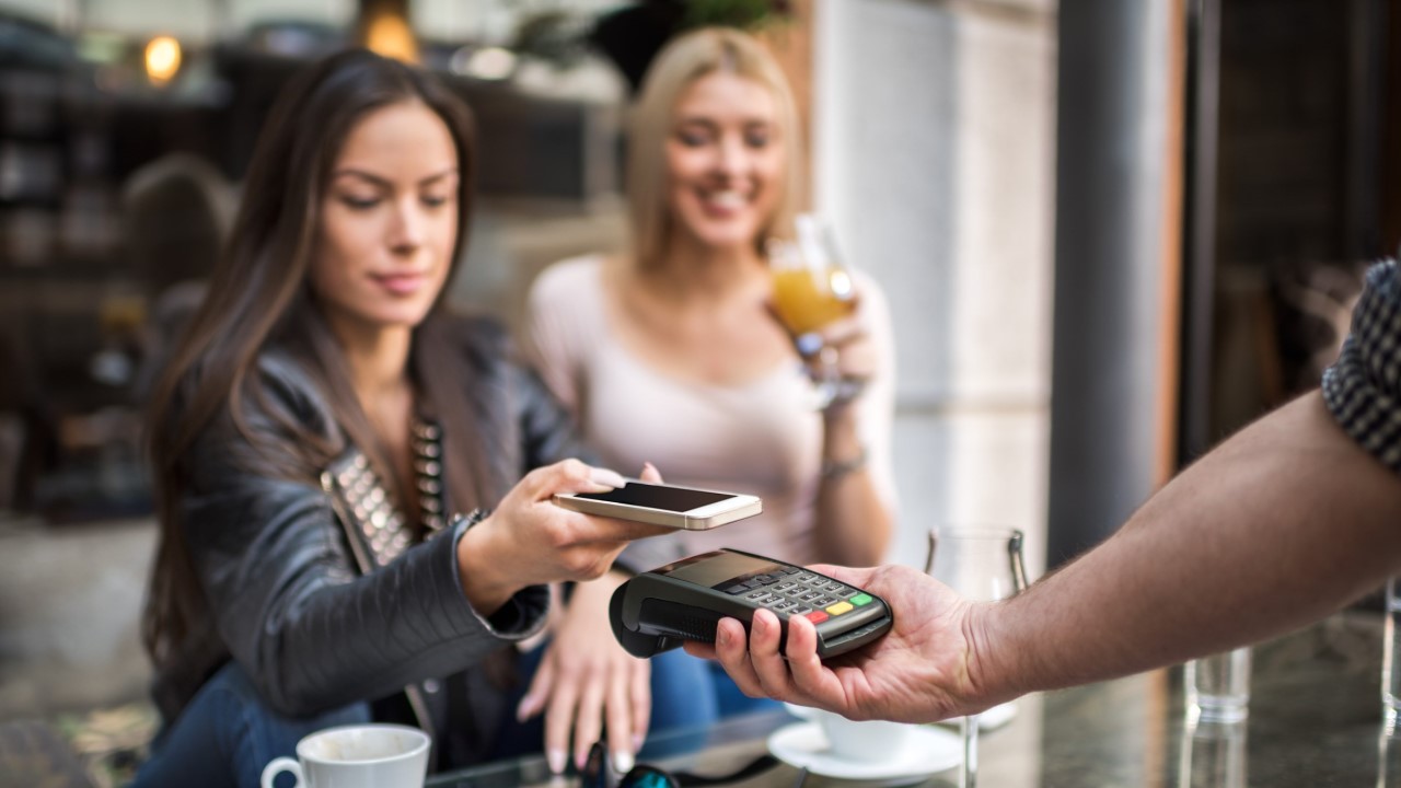 Woman using tap and go EFTPOS payment