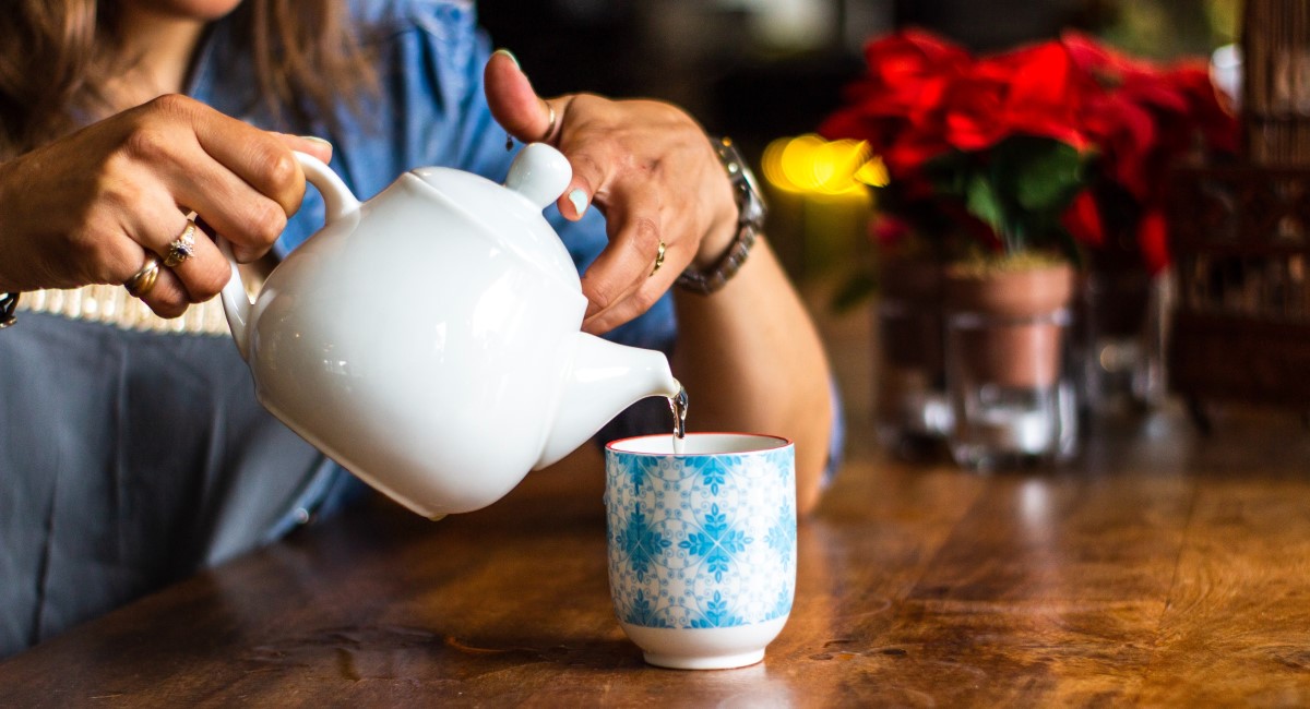 Woman pouring cup of tea