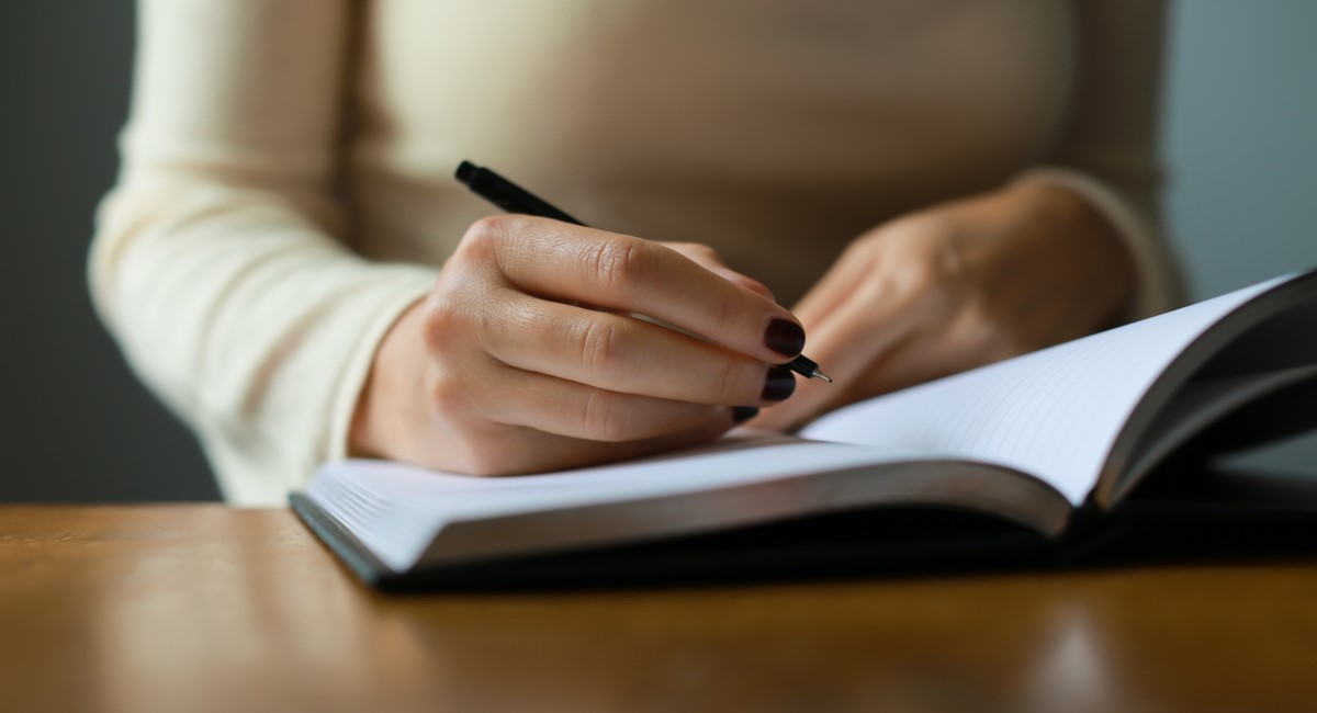 Woman writing in a notepad