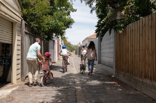 Family going for a bike ride in laneway