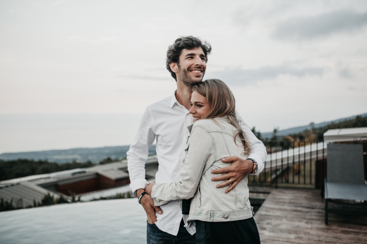 Younger man and woman hugging and smiling