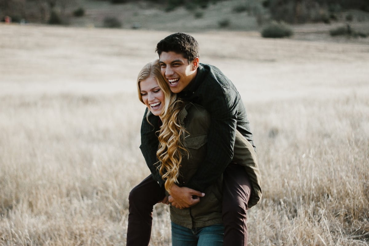 Woman giving man piggy-back ride