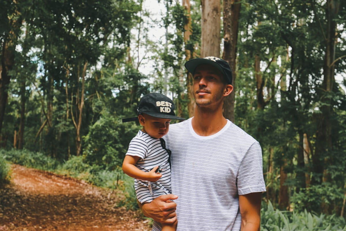 Man carrying toddler son