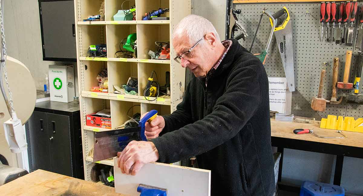 Fred Seeber doing woodwork in the shop at the Victoria Grange Retirement Community.