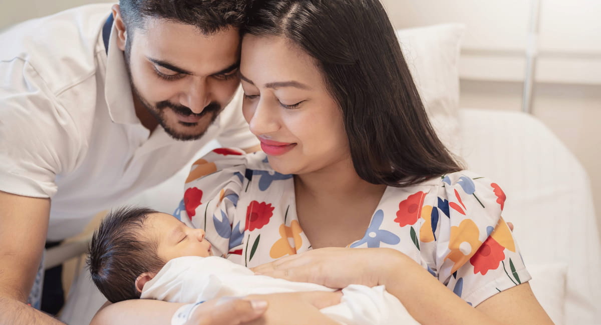 A young couple with their newborn