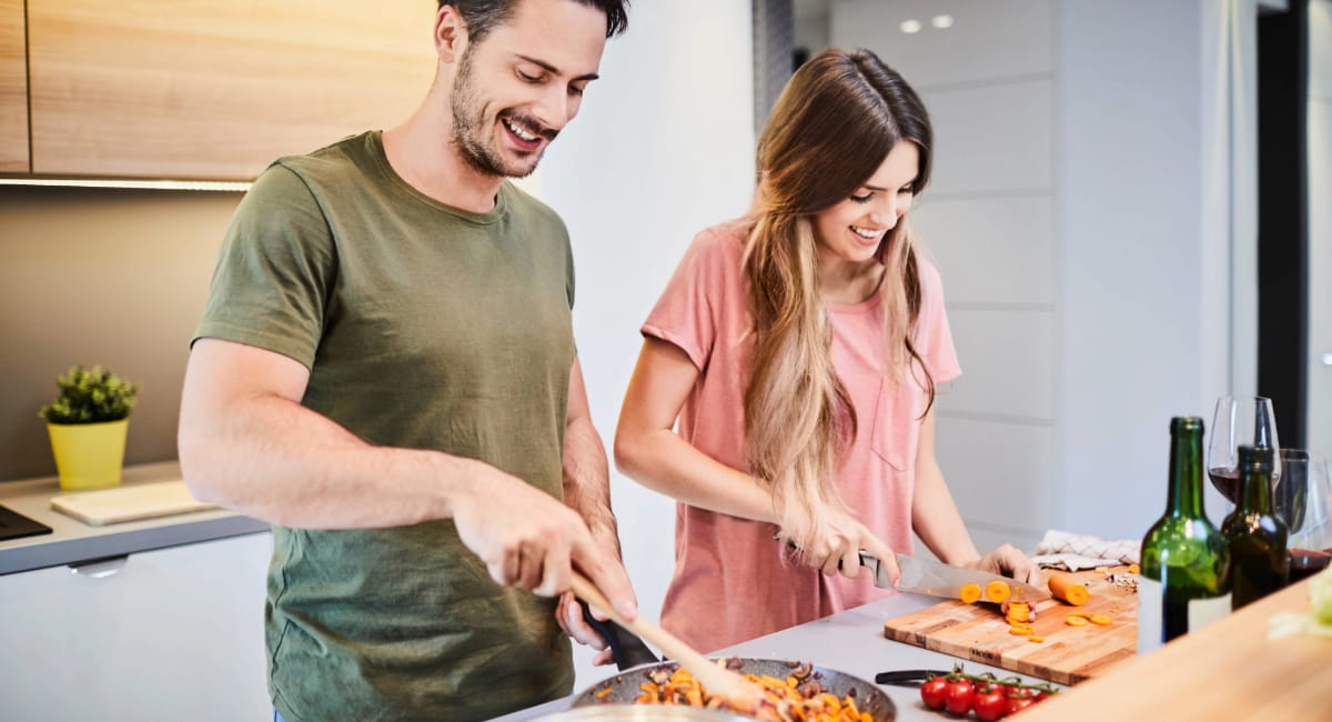 A couple preparing food together