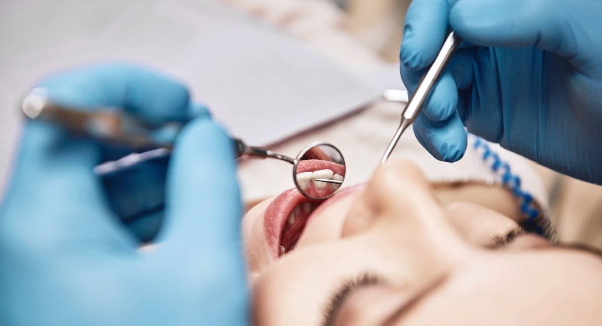 A woman receiving a dental check up from a dentist