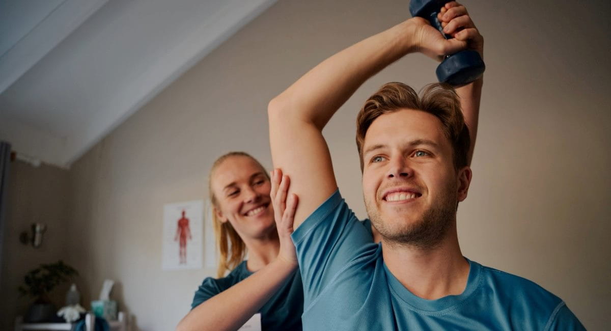 A young man receiving physio treatment from a physiotherapist