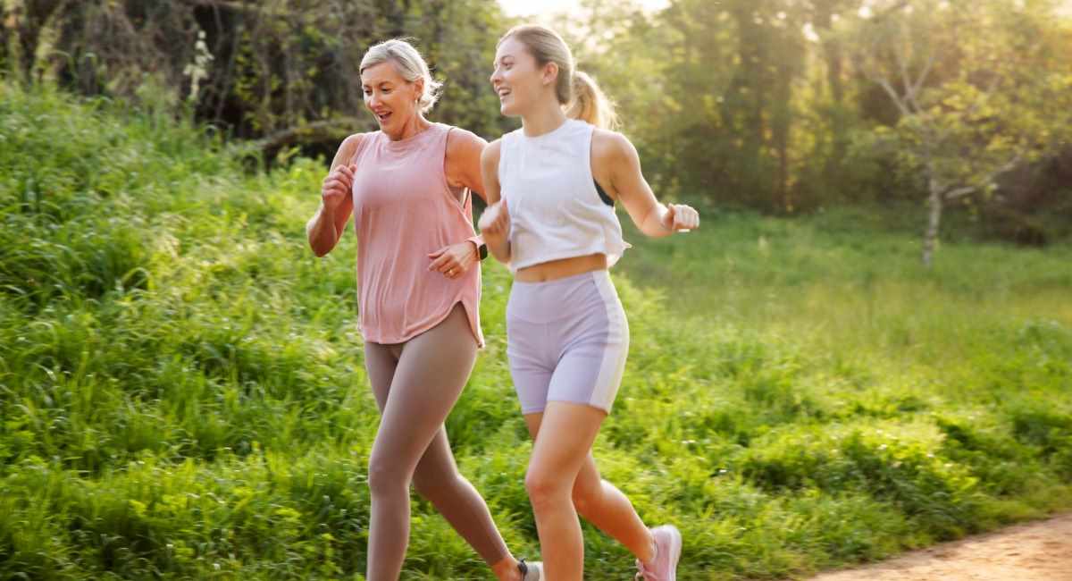 A middle aged woman and a young woman running in activewear
