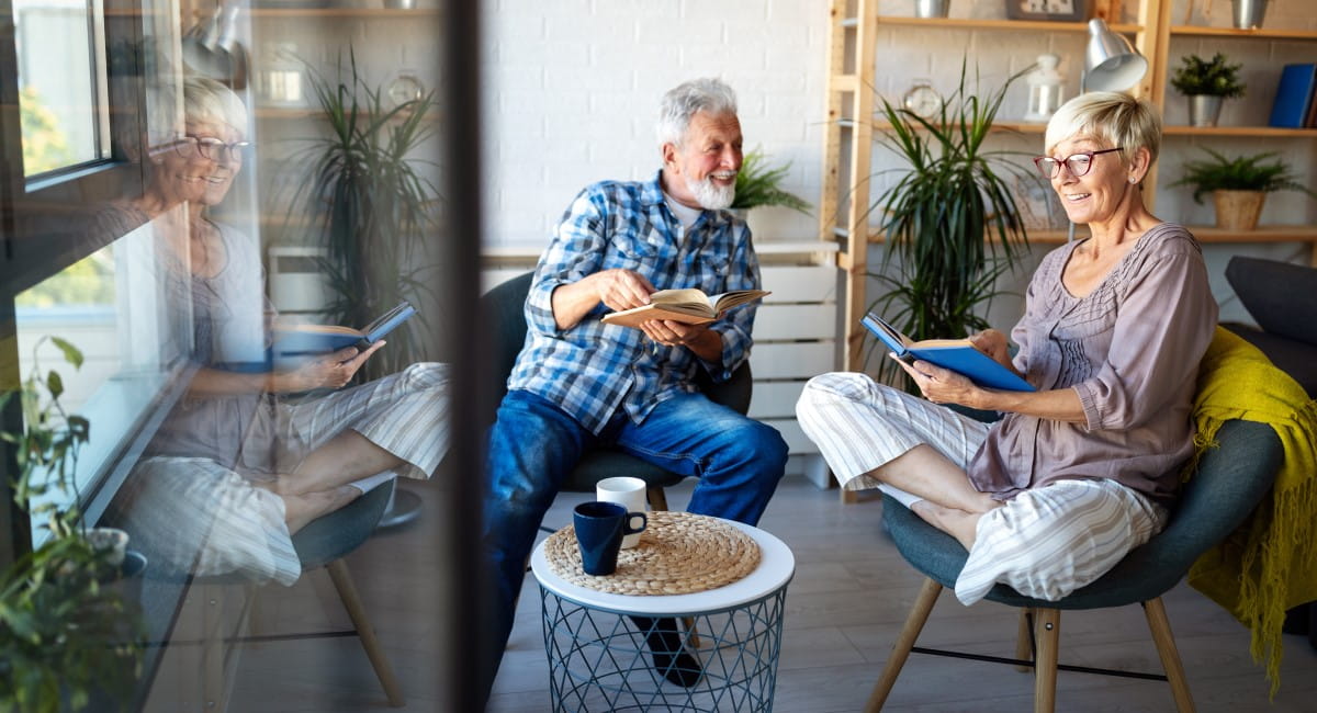 Older man and woman smiling and laughing at home