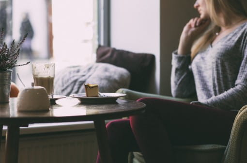 Woman sitting at table and looking out window