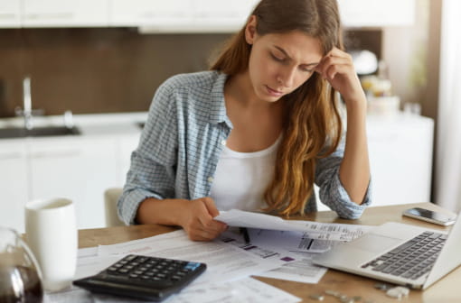A young woman stressing over bills