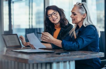 Photo of two women at a laptop