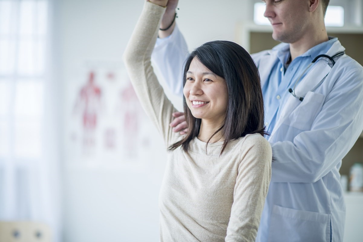 Smiling woman receiving Physiotherapy
